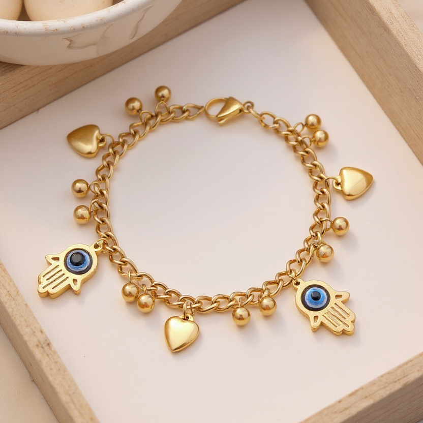 Gold bracelet with charms on a light wooden surface
