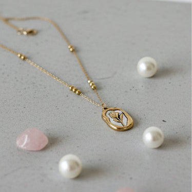 Collage of pearl necklaces on a neutral background